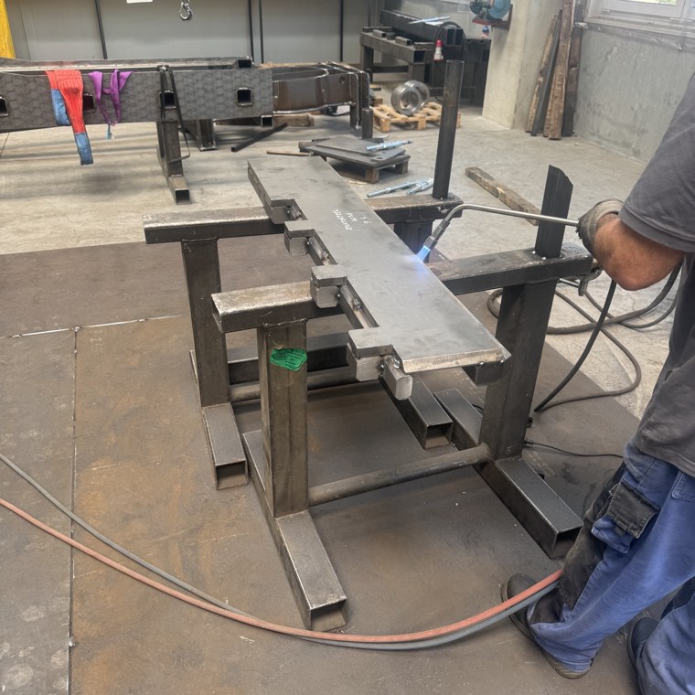 Welder at work on a steel frame in a certified weld shop